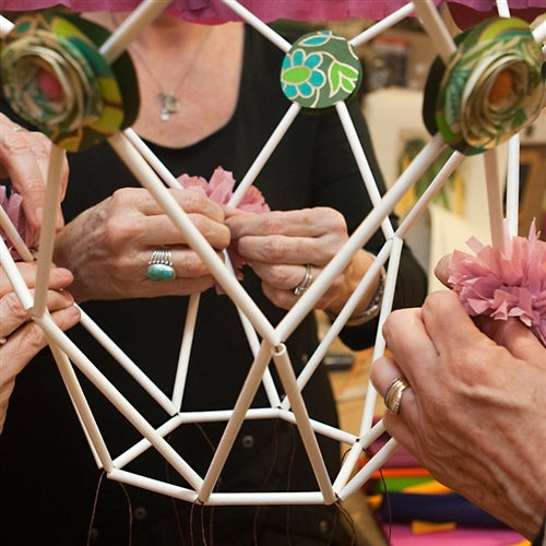 White paper craft straws being used to make a pajak