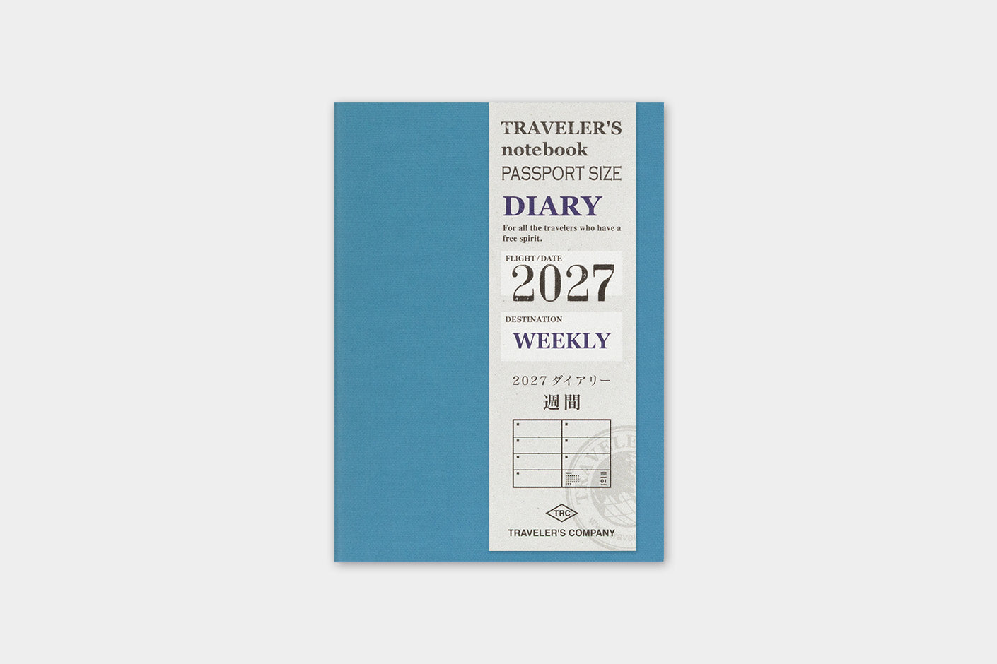 A 2027 weekly traveler's notebook by Traveler's Company, featuring a slate blue cover with a white vertical information wrapper detailing the text and year.