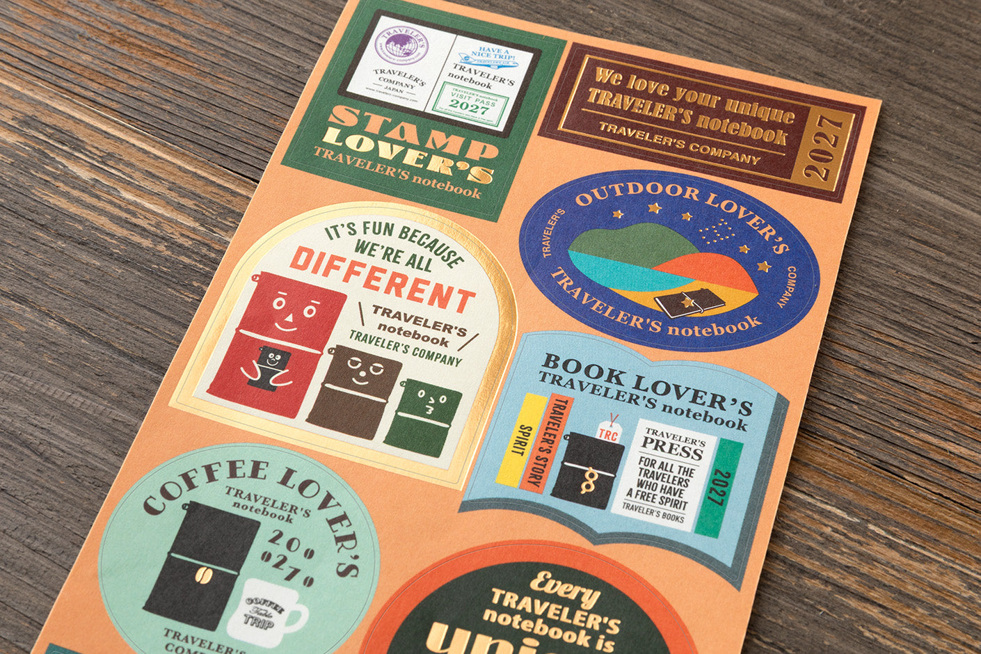 2027 stickers  with images and text such as 'Stamp Lover's Notebook,' 'Outdoor Lover's Traveler's Notebook,' 'Book Lover's Traveler's Press,' and 'Coffee Lover's Traveler's'