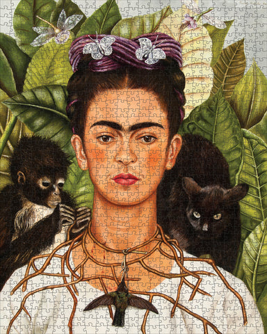 Frida Kahlo puzzle with a monkey, black cat, and butterfly on green leaves- finished puzzle example