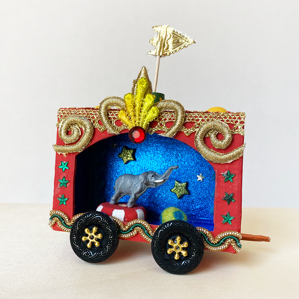 Vintage Circus Wagon Class sample with miniature elephant in decorated wagon with stars and flag