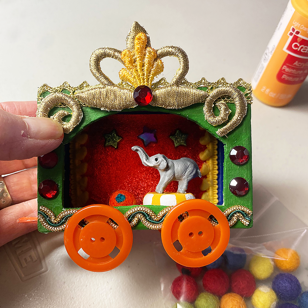 Vintage Circus Wagon Class sample with miniature elephant and colorful felt balls and craft pint