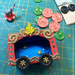 Vintage Circus Wagon Class sample in progress with small painted elephant and colorful buttons for wagon wheels