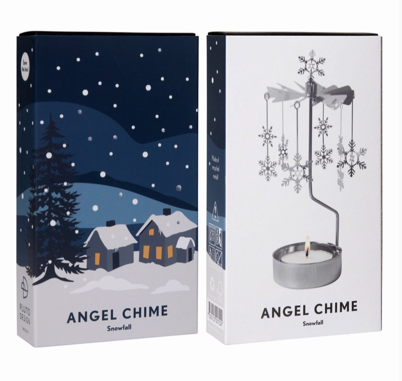 Two product boxes for an Angel Chime Snowfall, one showing an illustration of grey houses in snow white background and the other showing the silver metal snowflake chime with a tealight candle in a white box, set against a plain white background.
