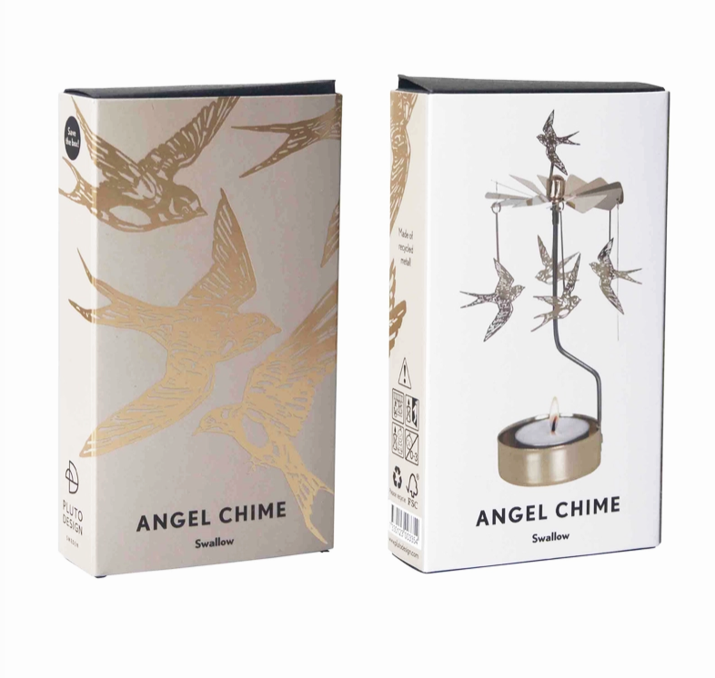 Two product boxes for an Angel Chime Swallow, one showing gold bird illustrations on a light beige background and the other showing the gold metal swallow chime with a tealight candle in a white box, set against a plain white background.