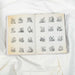 Open book with illustrations of letters on a white fabric background
