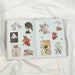 Open book with floral illustrations on a white fabric background
