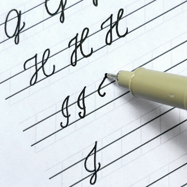 Pen writing on lined paper with a focus on letter formation.