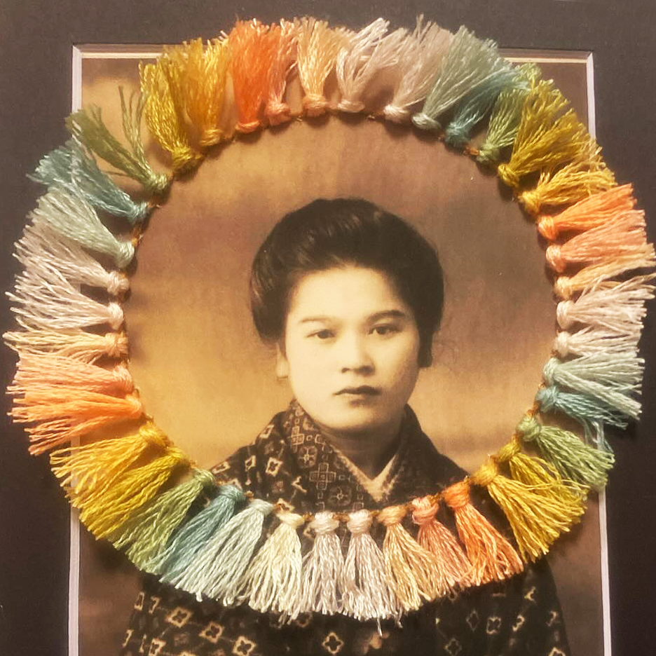 Embroidered vintage image - portrait of a Japanese woman with circle of tassels