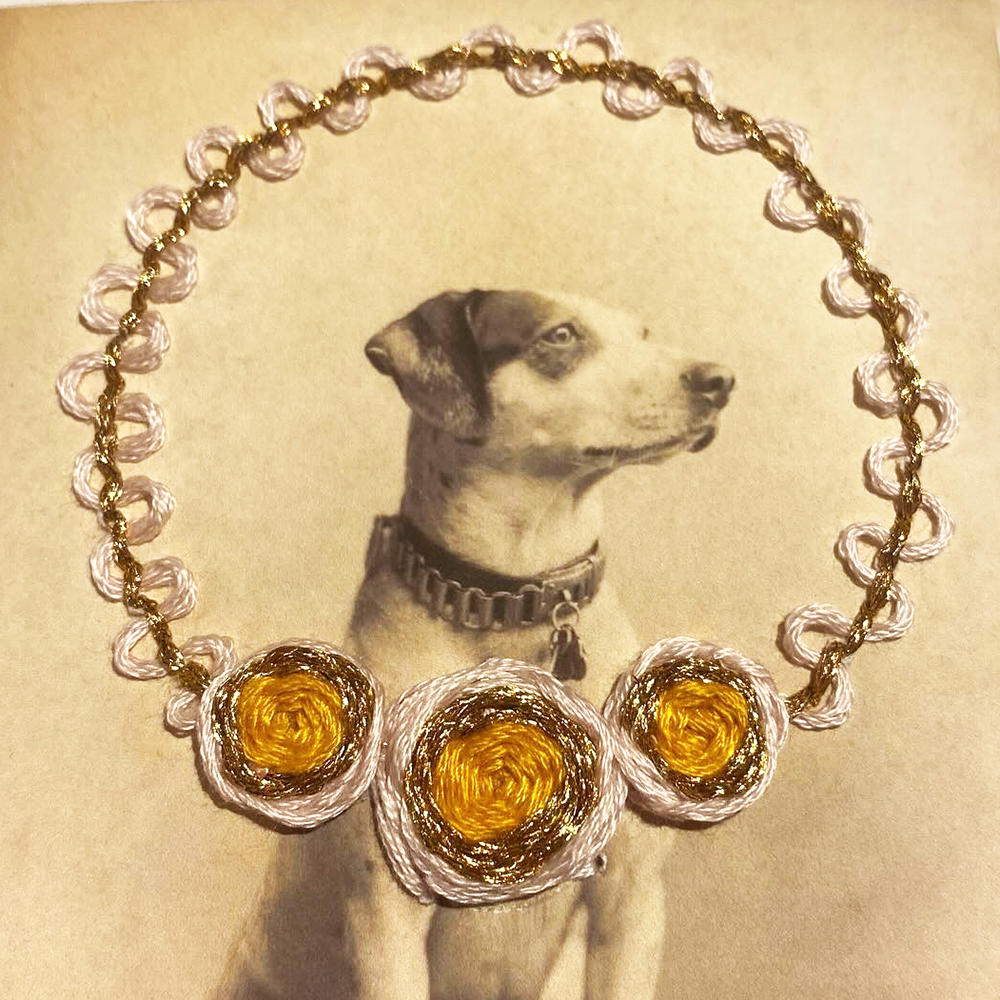 Vintage photo of dog with embroidered wreath framing head