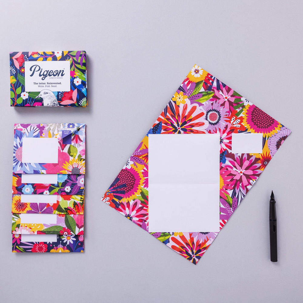 Colorful stationery set with floral design on a gray background