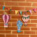 Decorative hot air balloons and colorful bunting on a brick wall
