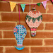 Decorative hot air balloons with colorful patterns on a brick wall.