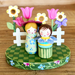 Decorative wooden peg dolls with flowers on a checkered base