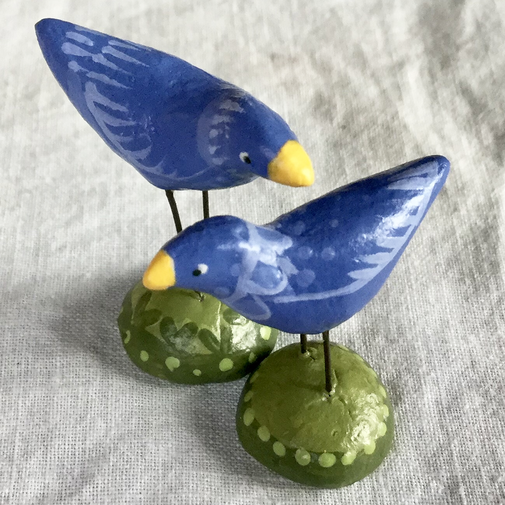 detail of painted clay blue birds