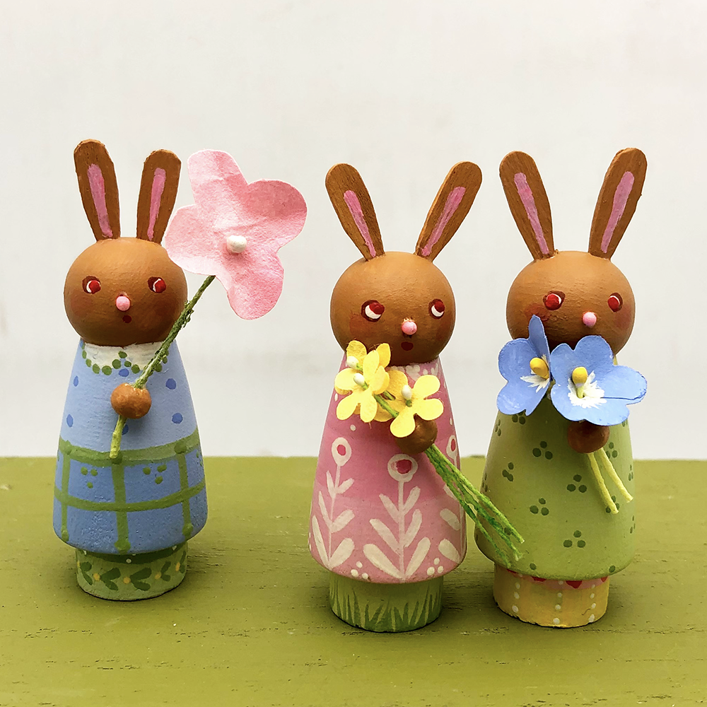 Wee Bunnies Three!  class samples- three peg doll bunnies holding flowers on white background.