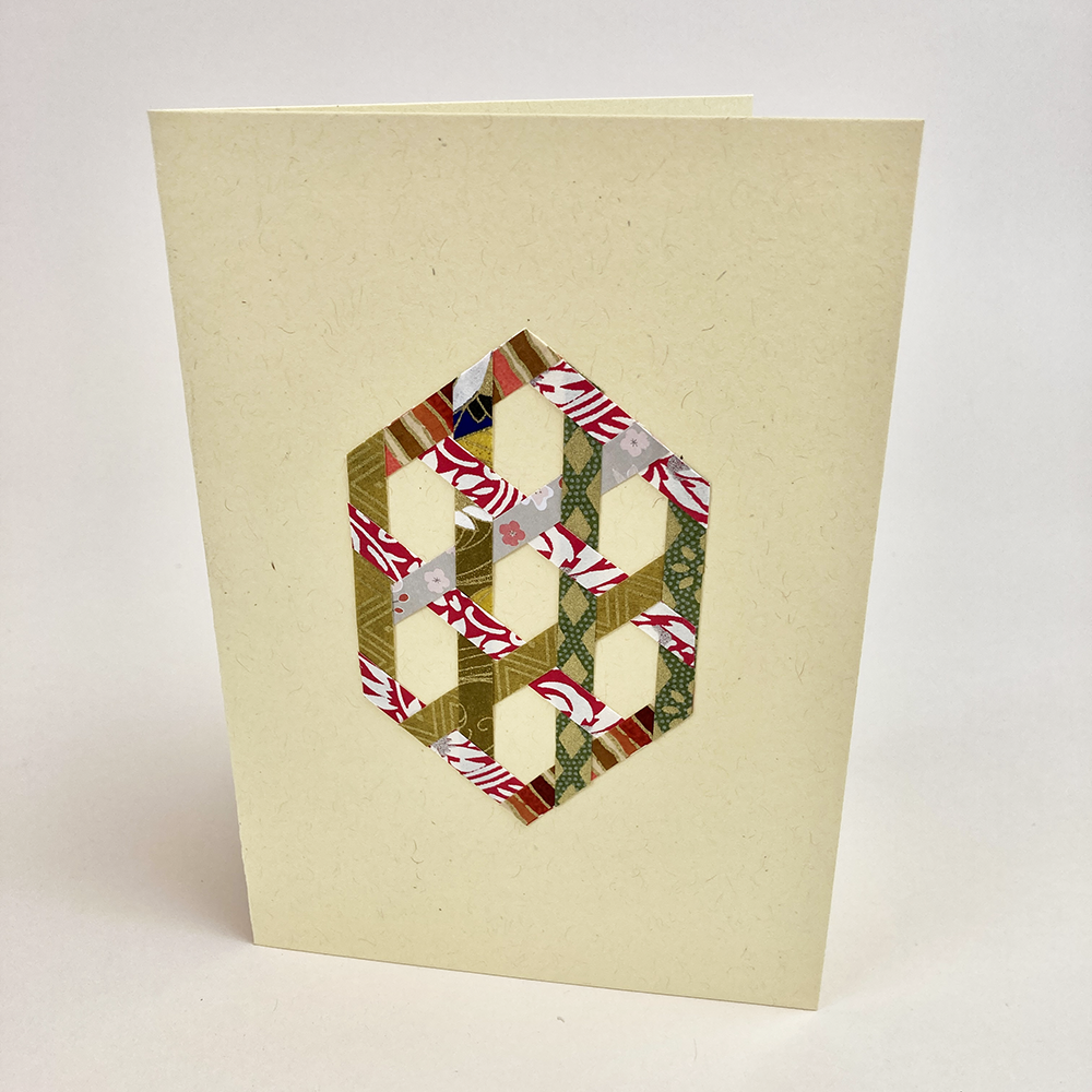 Card with woven hexagon geometric paper design on a beige background