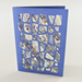 Greeting card with Japanese patterned paper design on a white background with blue cut paper geometric pattern laid on top.