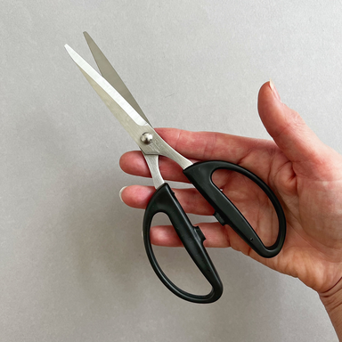 Kai Crafting Scissors shown in hand- 7.5”  
