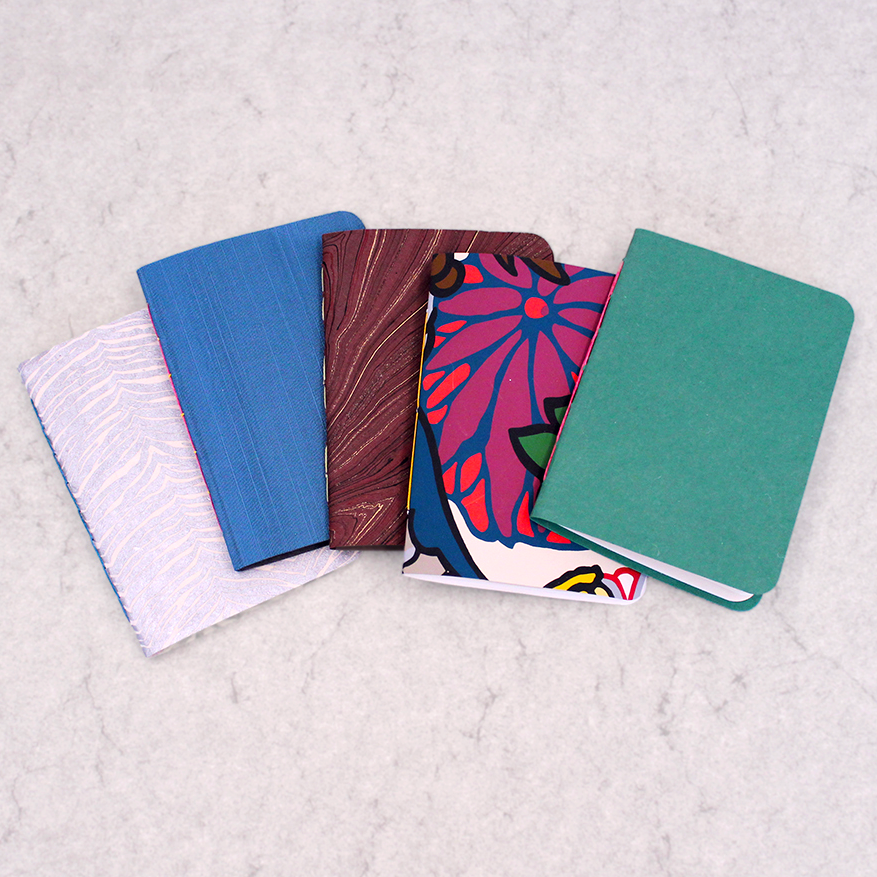 Basic Booklets, Splendid Stitches- 5 class samples with different covers spread out on a table