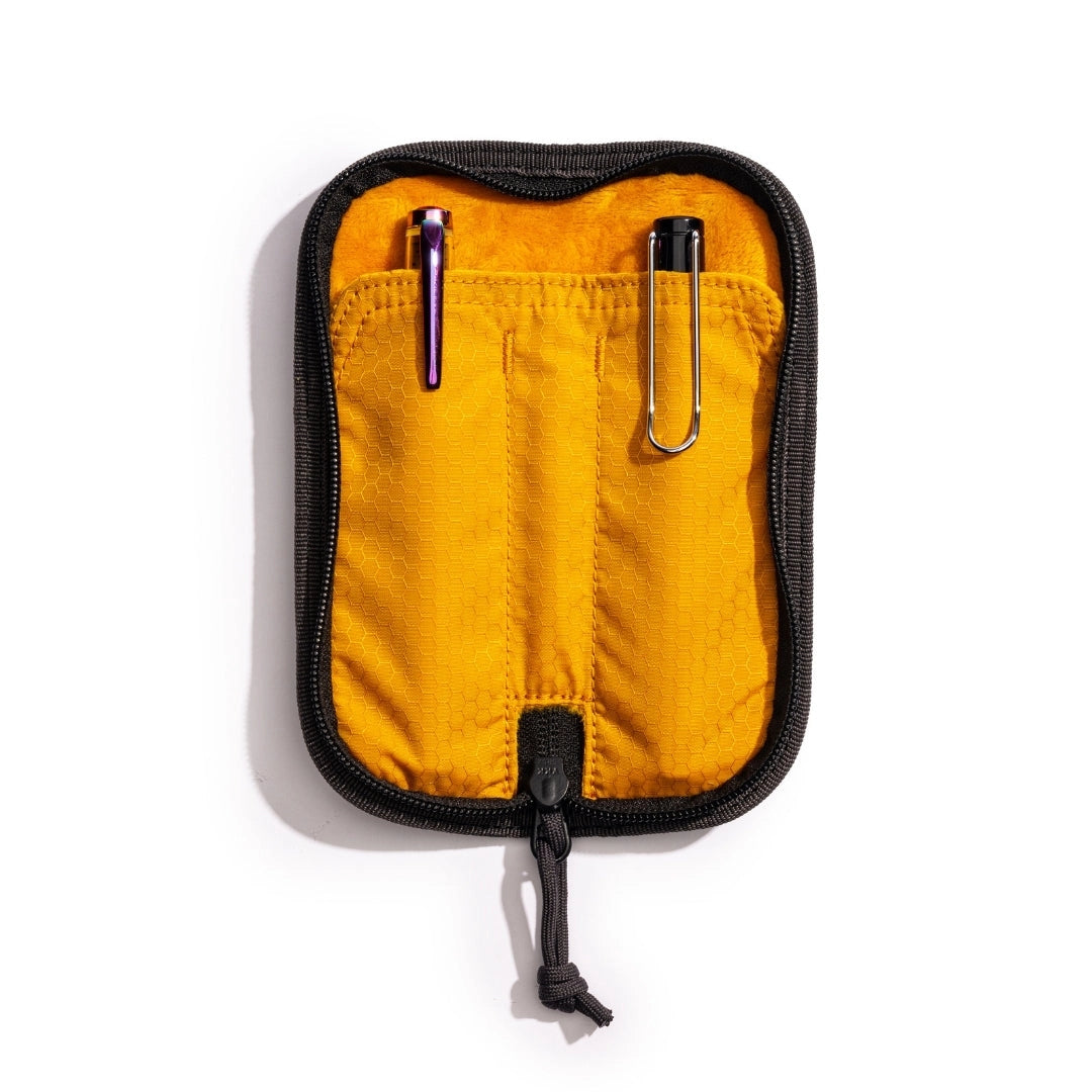 Lochby Duo Pen Pouch, black in color shown lying open with yellow interior and two sample pens (not included) show in pouches