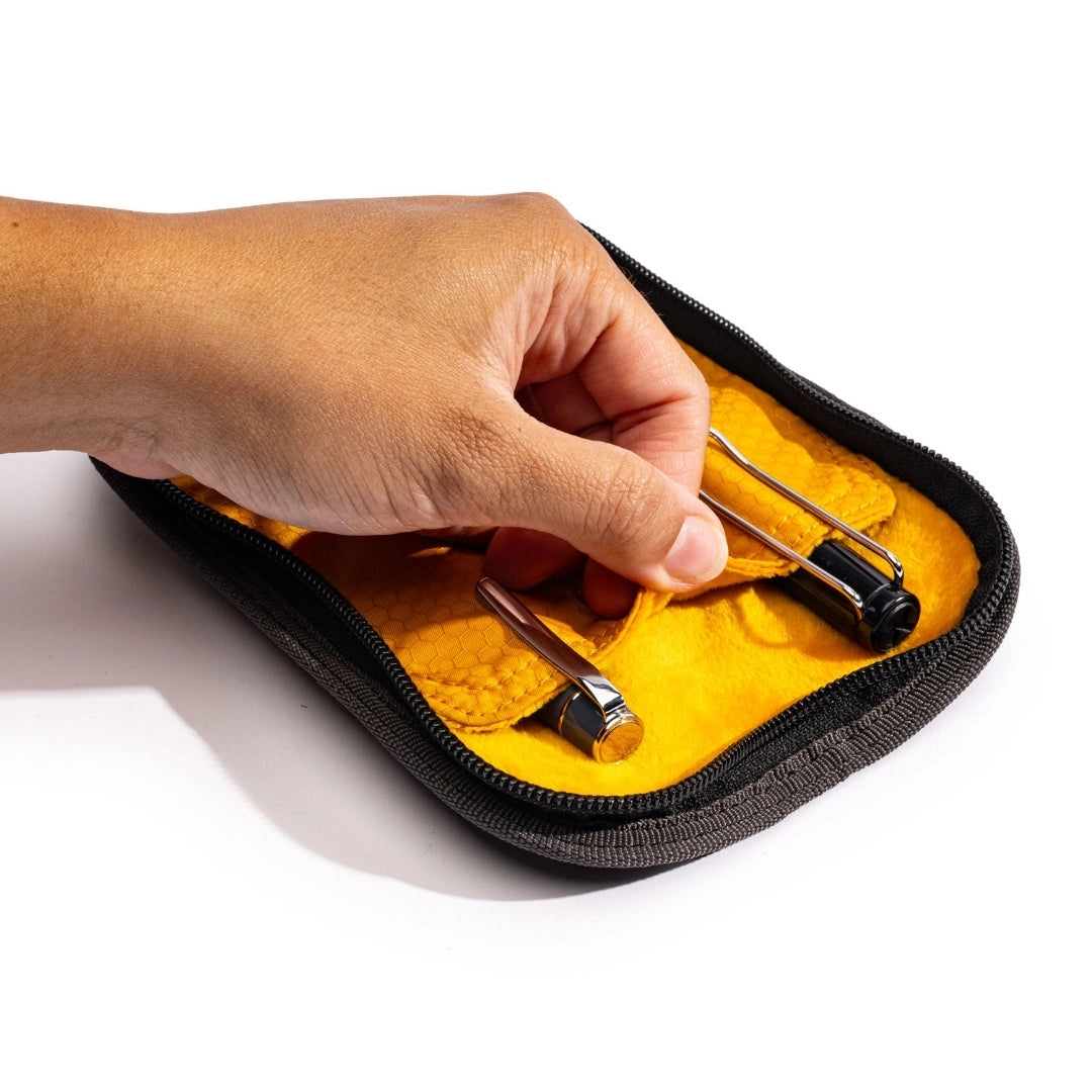 Lochby Duo Pen Pouch shown lying open with yellow interior, with two sample pens (not included) 