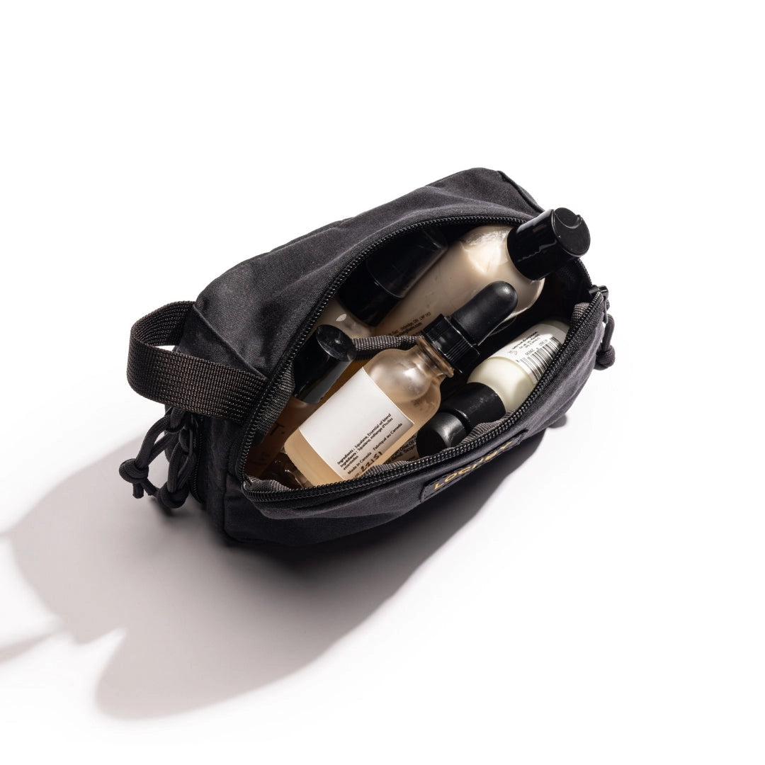 Lohby Mini Venture pouch used as a bag for toiletry products on a white background.  Items shown in pouch not included. 