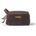A dark brown canvas toiletry bag with a top zipper, a brown webbing handle, and a tan leather patch with gold lettering that reads 'LOCHBY'.