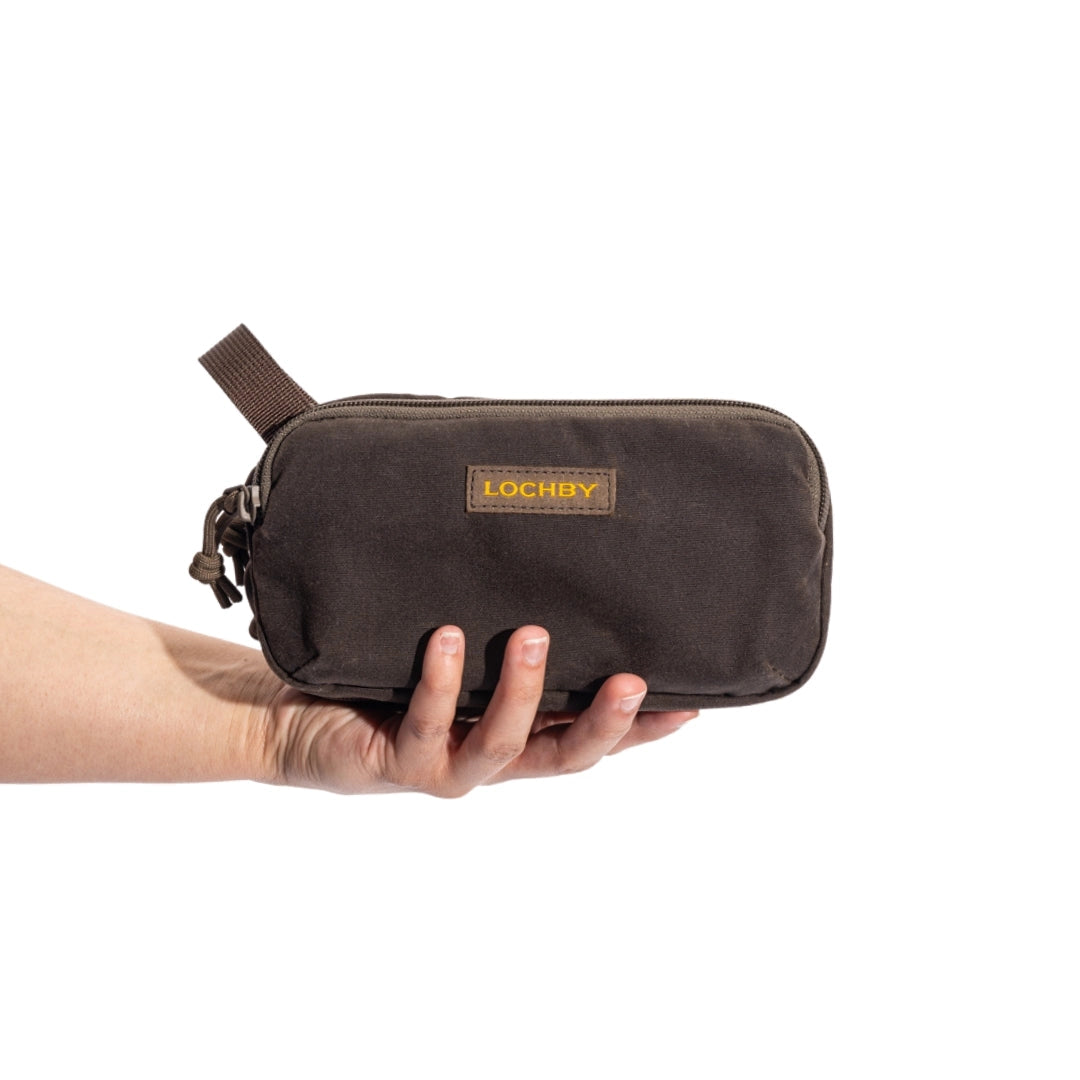 Brown bag with 'Lochby' branding held by a hand on a white background