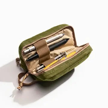 Lime Mini Venture Pouch shown open with pens and a pencil inside. The pouch has a small strap for carrying and is photographed on a clean white background.  Items shown in pouch not included. 