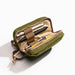 Lime Mini Venture Pouch shown open with pens and a pencil inside. The pouch has a small strap for carrying and is photographed on a clean white background.  Items shown in pouch not included. 