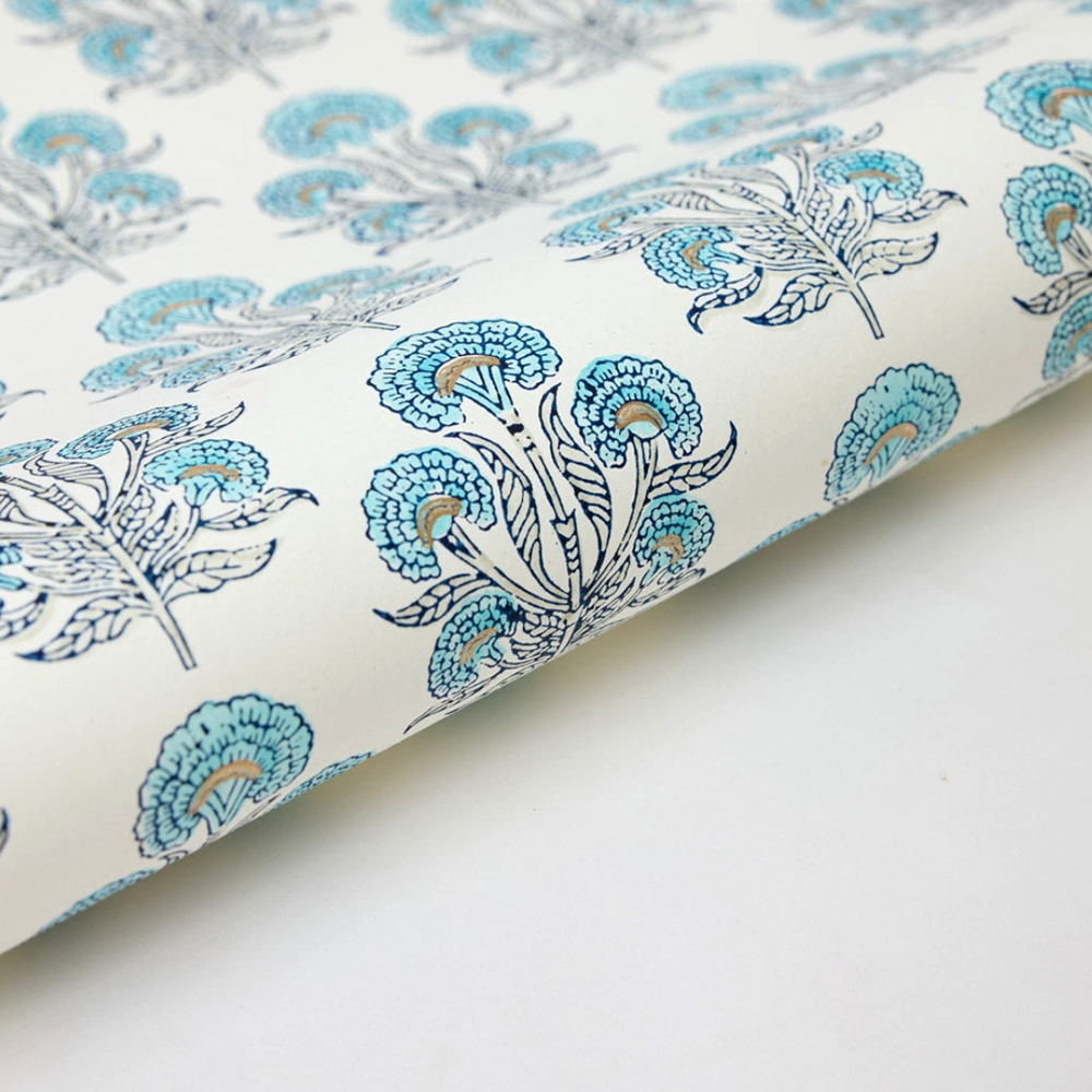 Floral-patterned paper with turquoise and dark blue flowers on a white background with gold accents- detail