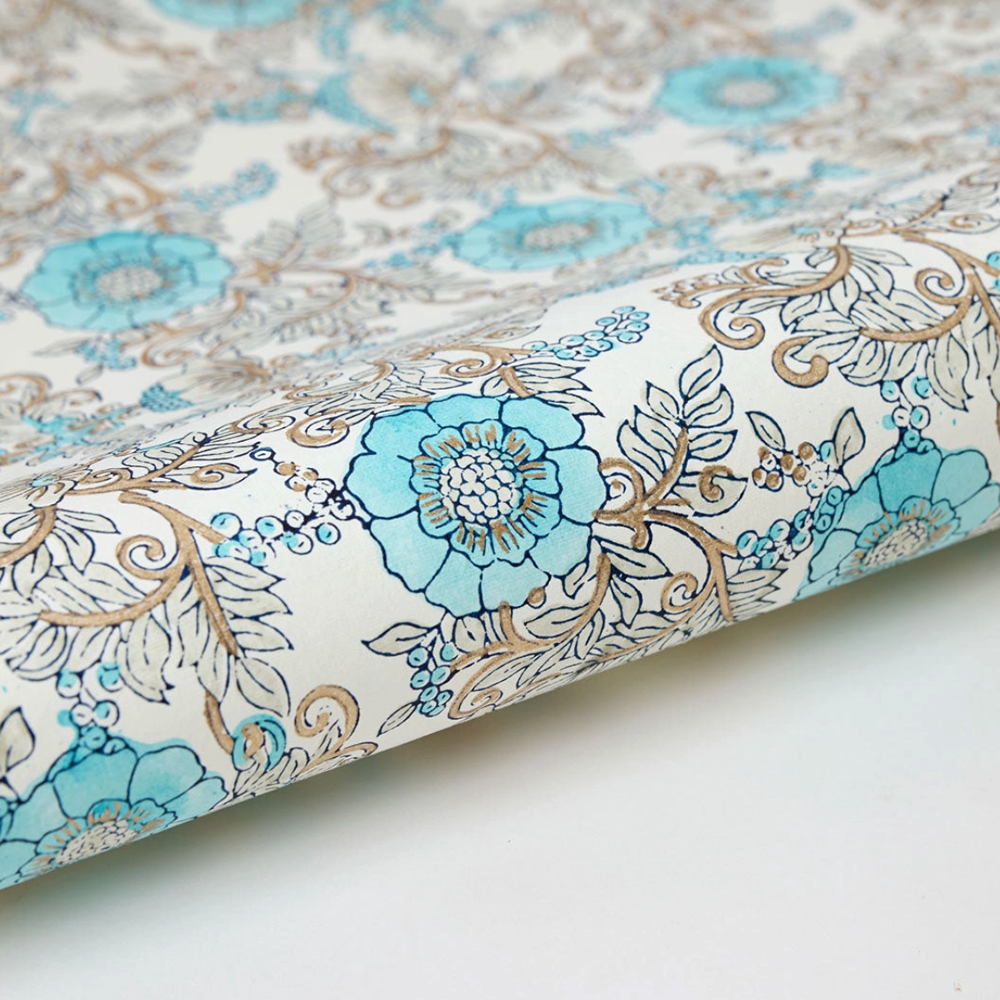 Wild rose and leaf patterned paper with turquoise and dark blue on a white background with gold accents- detail