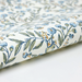 Floral and bird patterned paper with blue flowers and green leaves on a white background- detail