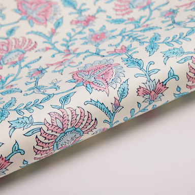 Block printed pink flowers with light blue leaves on white background- detail