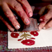 Artist hand stamping card with block print in hands