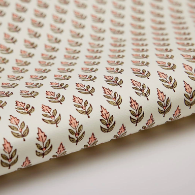 Roll of paper with a floral repeat pattern on a white background