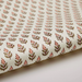 Roll of paper with a floral repeat pattern on a white background