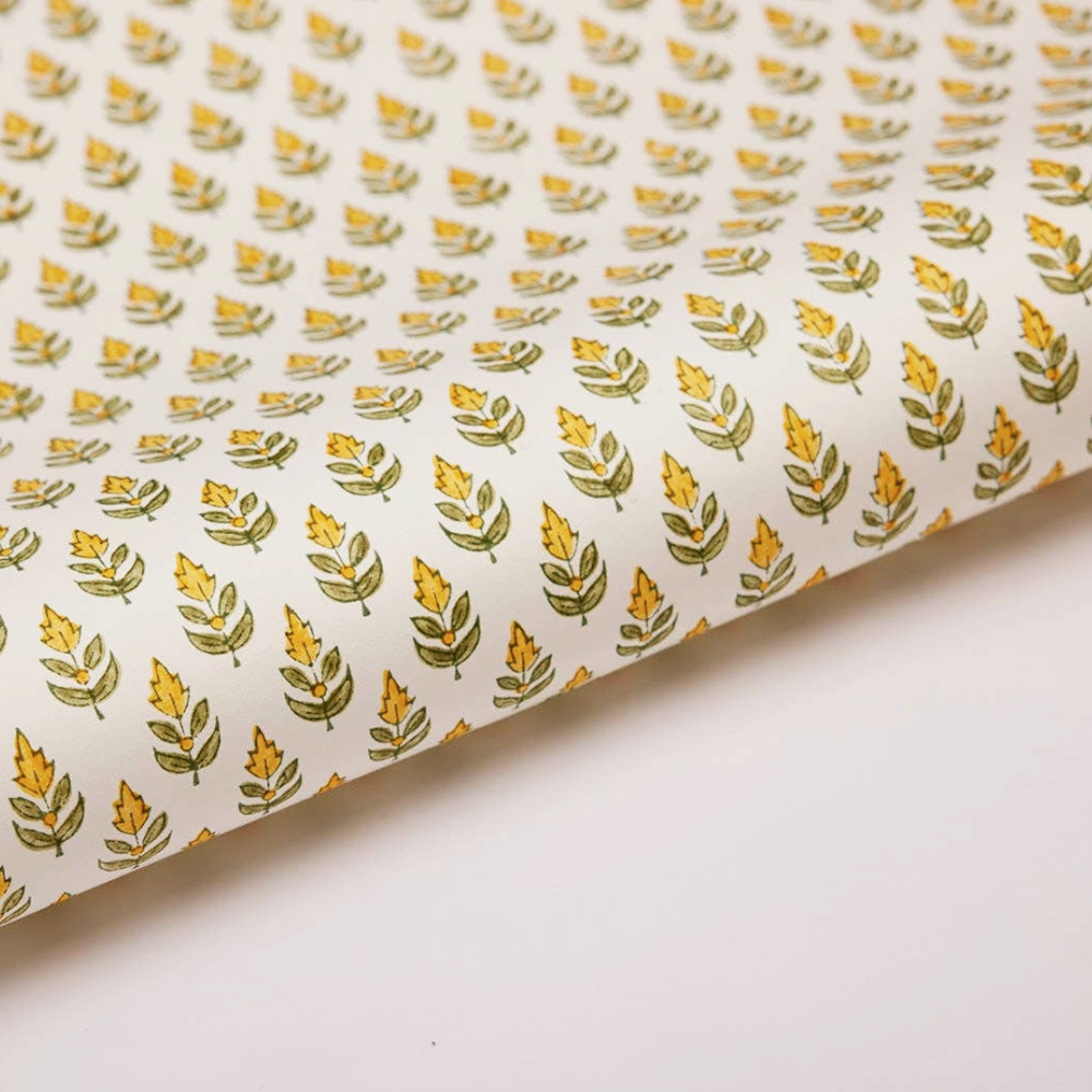 Paper with a repeat flower and leaf pattern on a white background