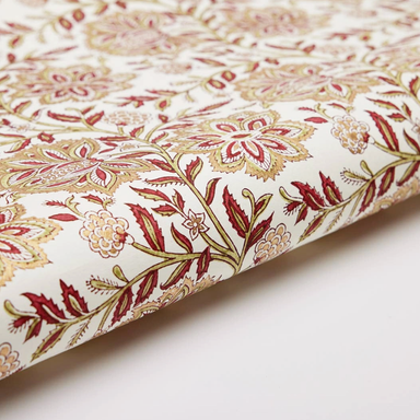 Floral patterned paper with red, gold and green design on a white background