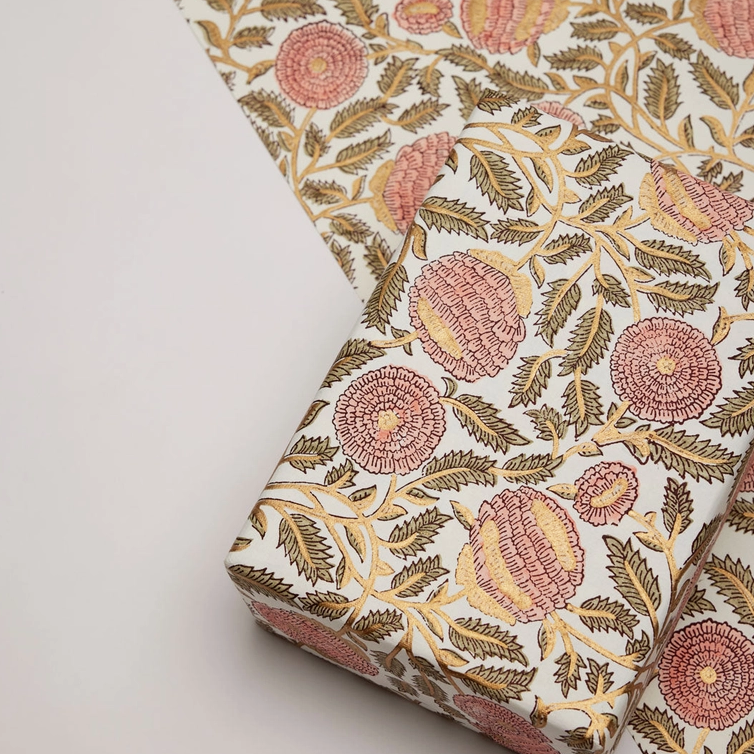Floral patterned paper with one flat sheet along with a wrapped box in the same paper