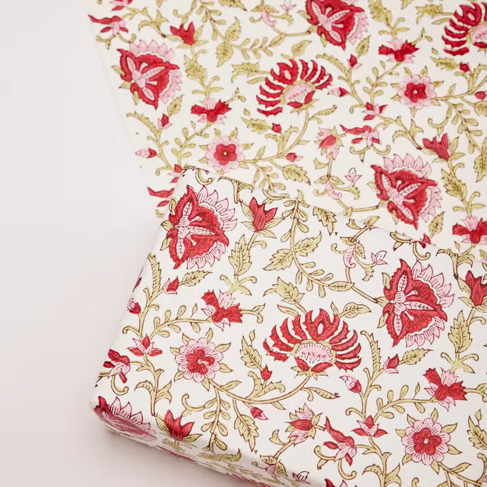 Red and pink flowers with green leaves on white background used as a gift wrap and also shown with flat sheet