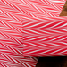 Handmade Indian Cotton Paper- Marbled Candy Stripes red on white used to wrap a package and shown with flat sheet