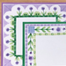 Decorative paper with floral border and grid design on a wooden surface
