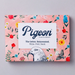 Pigeon letter writing kit packaging with illustrations of flowers in a variety of colors on a pink background.