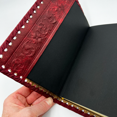 Red Sacred Heart Refillable Leather Journal showing interior embossing and journal refill