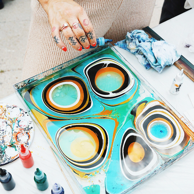 Painting on Water - An Introduction to Marbling class sample of a person creating a pattern