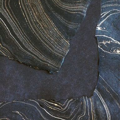 Handmade Marbled Paper- Black with Silver and Gold showing front and back sides with edge deckle