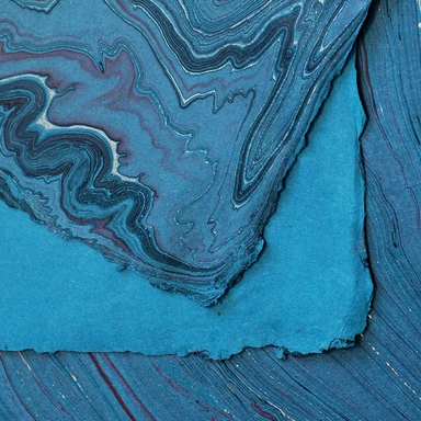 Handmade Marbled Paper- Dark Blue with Gold, Black and Red showing front and back sides with edge deckle