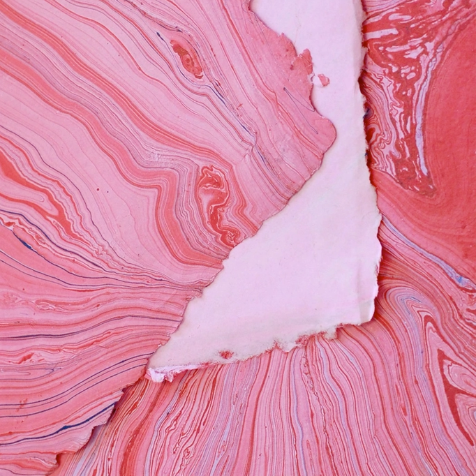 Marbled Paper- Hot Pink with Red and Blue showing front and back sides with edge deckle